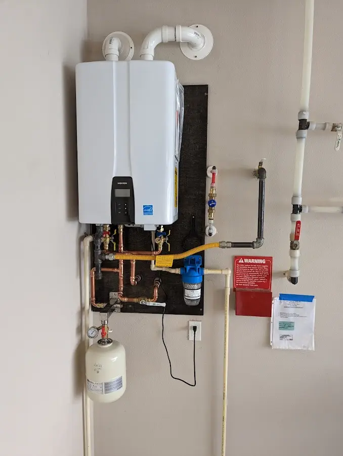 Professional plumber installing copper piping in a Red Chute home